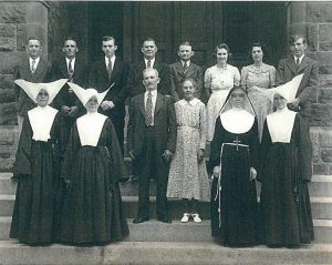 Front row, left to right:  Elizabeth Ann Simms (Sister  Denise), Elizabeth Viola Simms (Sister  Genevieve), John Francis Simms (Father), Mary Pauline Shorter Simms (Mother), Elizabeth Geraldine Simms (Sister  Edith), Mary Magdalene Simms (Sister  Mary Magdalene) Back row, left to right:  Benjamin  Frank Simms, Francis Jerome Simms, Joseph Vernon Simms, John Wade Simms,  James Herbert Simms, Agnes Irene Simms Clement, Evelyn Cecilia Simms Weisbrod, Joseph  Leonard Simms Not pictured: Gladys Simms Stansbury